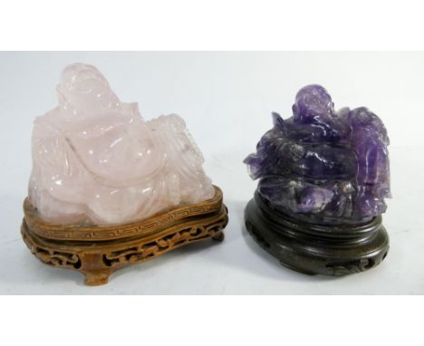 Carved rose quartz seated Buddha and a carved amethyst Buddha both mounted on carved hardwood bases, rose quartz Buddha measu