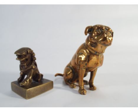 A Victorian model of a brass seated mastiff dog and a small bronze temple lion seal on square bass. Brass dog height 8cms 