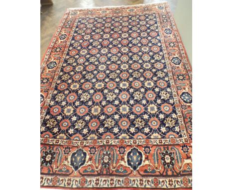 A large red and floral patterned Persian carpet approx 3mtrs x 2mtrs   overall in good condition no signs of damage or fading