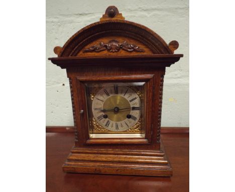 An Edwardian striking bracket clock with brass and silver dial in oak case 36cms high, 25cms wide