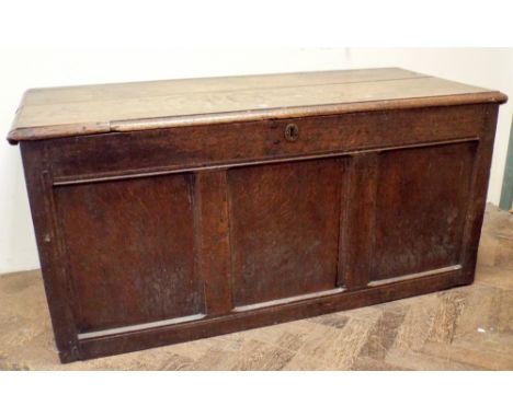 An antique oak three panel coffer 127cms wide 