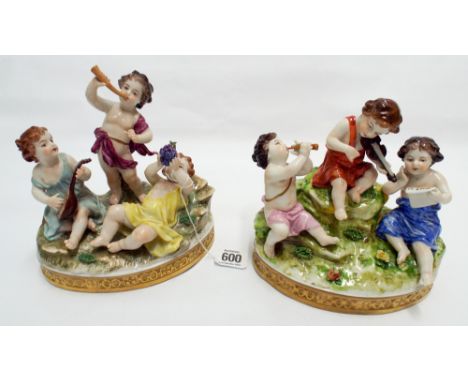 A pair of continental porcelain figure groups of cherubs playing musical instruments on oval bases height 18cm