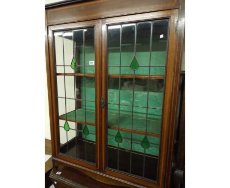 An Edwardian inlaid mahogany china display cabinet with two leaded glazed panel doors 