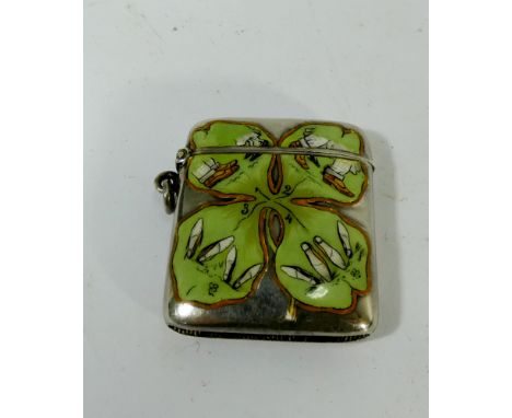 An Edwardian novelty enamelled vesta case, the sterling silver case decorated with a Shamrock design and a risque step to lov