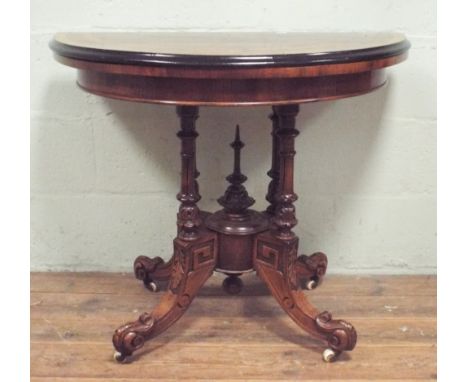 A Victorian walnut D shaped folding top card table on quadruple style base, 90cms diameter when open   There are scuffs to th