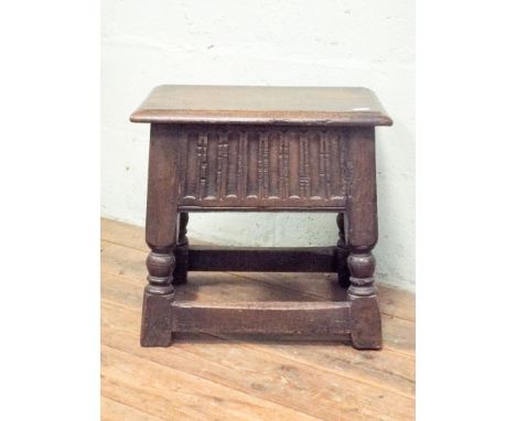 An antique carved oak coffin stool on turned legs with lift up storage lid 46cms by 28cms and 45cms high 