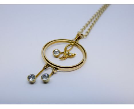 Edwardian aquamarine and seed pearl pendant, of circular form with millegrain aquamarine droppers. Stamped 15ct, on 9ct gold 