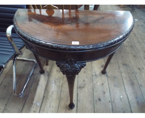 A Georgian style semi circular mahogany folding top card table on cabriole style legs with pad feet 2'9 wide 