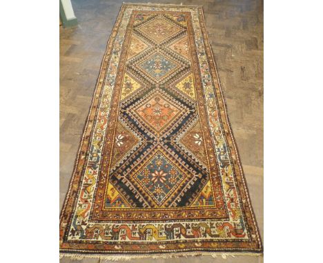 A figured wool pile Persian carpet runner 313cms long, 106cms wide   In good condition just faded slightly fringes are very f