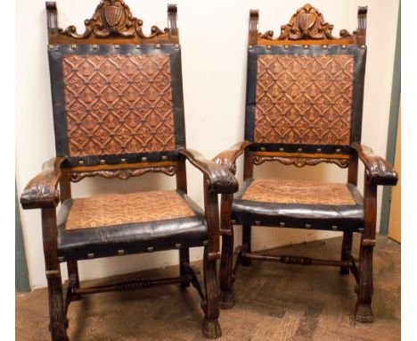 A pair of continental walnut framed elbow chairs backs with inset shield panel,  seats and back upholstered in embossed leath