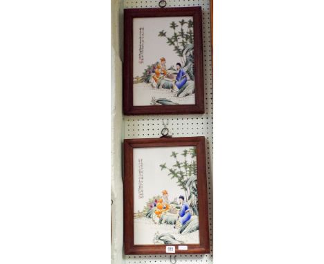 A pair of framed Chinese porcelain panels, people playing chess and three other similar framed panels 