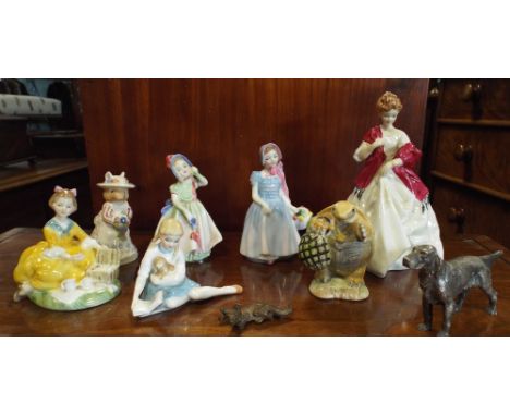 A collection of Royal Doulton and Worcester figurines, a miniature bronze of a fox and a silver plated setter dog.