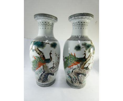 A large pair of Chinese vases decorated with peacocks, calligraphy script to reverse, both drilled for lamp bases, height 47c