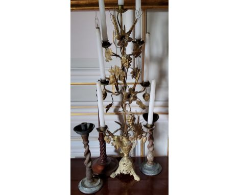 An ornate French gilt metal six light candelabra, a two handled urn holding a central post decorated with Madonna lilies, gra