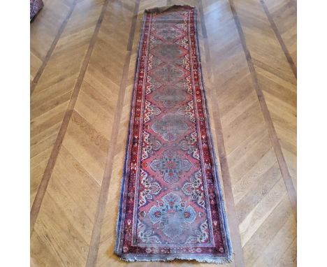 A hand knotted Persian Sarab runner, in tones of turquoise and rich reds, 411cm long x 90cm 