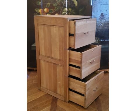 A contemporary light oak campaign style three drawer filing cabinet with brass drop handles of good solid construction, 50cm 