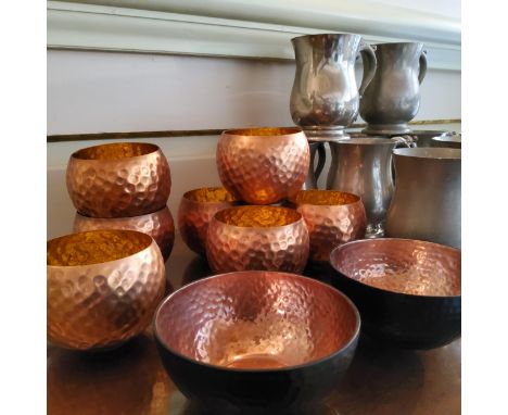 Nine Sheffield pewter tankards; seven plemished copper tea light holders; two painted copper bowls 