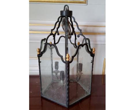 A glazed wrought iron 3 light hall lantern, gold painted finials 46cms high (PAT tested) 