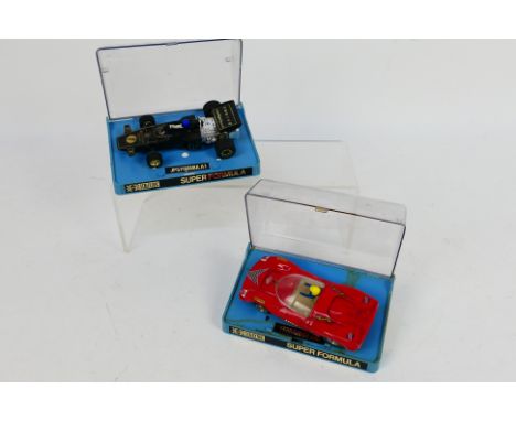 Scalextric. Two Electric model cars for Scalextric housed in Plastic Display Cases. Items appear in Excellent condition and i