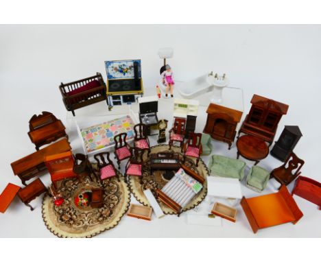 Dolls house furniture. A quantity of dolls house furniture including beds, chairs, toilet, dressers, crib, clock, bath and mo