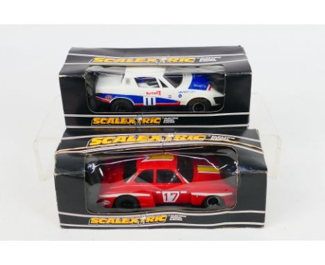 Scalextric. Two boxed Electric model cars appearing in Excellent condition in VG boxes with some storage wear. #C128 BMW Turb