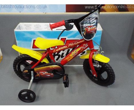 Dino - A boxed Dino Lightning McQueen 12" Childrens Bicycle. The item appears to be in Excellent condition and is retail stoc
