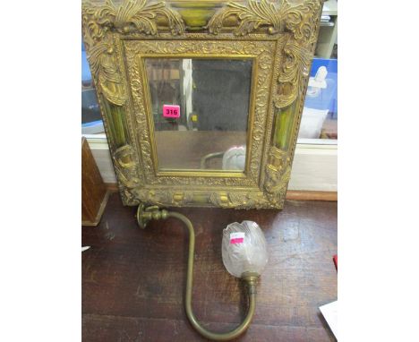 A modern gilt framed mirror and a brass gas lamp with a glass shade