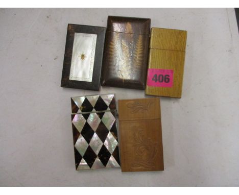 Five 19th century and later card cases to include three wooden examples, a mother of pearl and tortoiseshell, and another wit