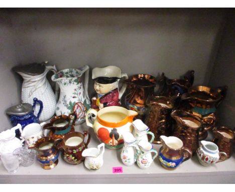 A quantity of early to mid 19th century  graduating ceramic lustre jugs and others to include a Clarice Cliff jug, A/F