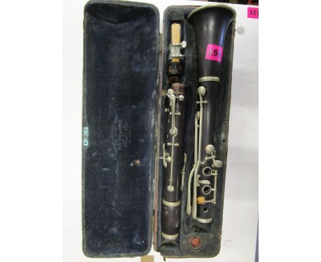 An early 20th century rosewood clarinet, the velvet lined interior of the case marked Maino & Orsi, Milano
