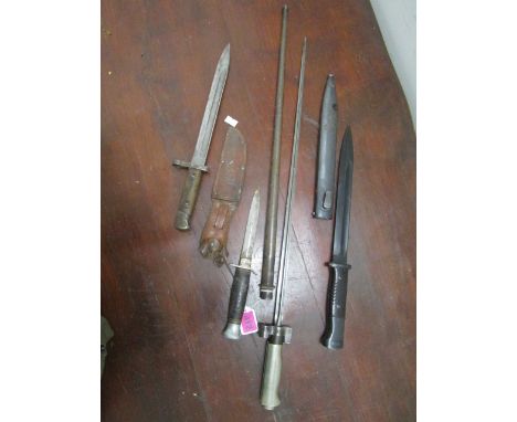 A group of three bayonets to include a stick bayonet in metal sheath and a K55 German knife in leather sheath