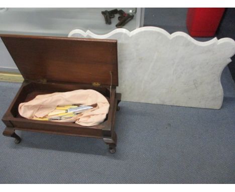 A mid 20th century low table with a hinged top, cutlery and a white marble top