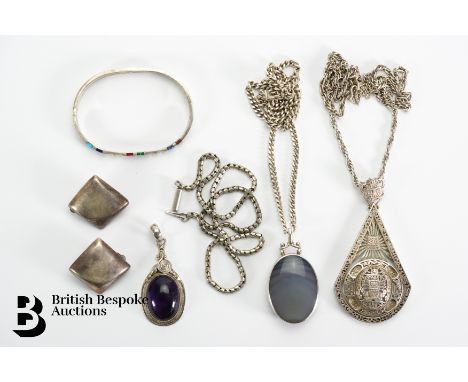 A large Aztec pendant suspended from a rope chain approx 60 cms in length, 43 gms; Mexican silver bangle heightened with colo