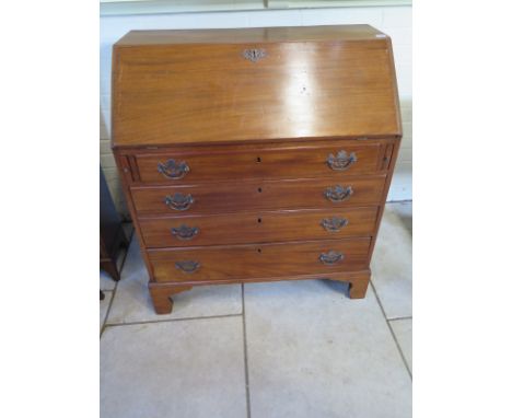 A Georgian mahogany bureau with fitted interior over four long drawers on bracket feet - 106cm H x 94cm x 51cm - removed from