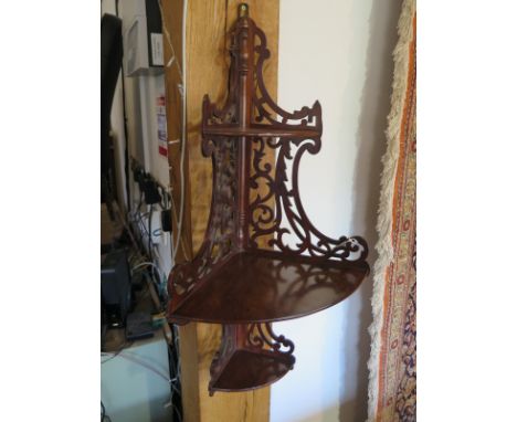 An early 20th Century mahogany corner shelf 