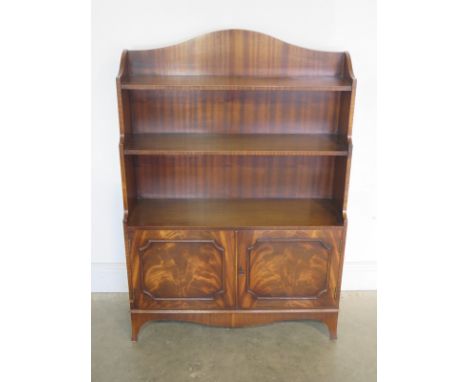 A mahogany mid 20th Century bookcase cabinet on shaped bracket feet - in good condition - 121cm tall x 84cm wide 