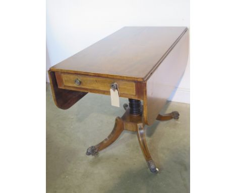 A Regency mahogany and cross banded pedestal sofa table with two end drawers and brass caps and castors - in good restored co