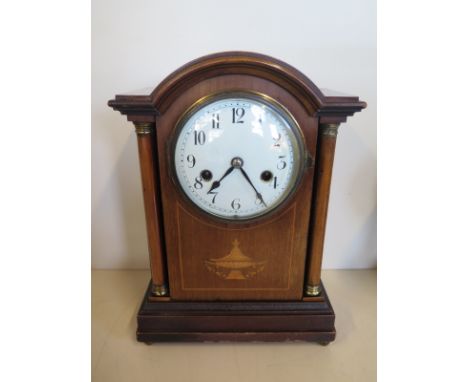An 8 day mantle clock with box wood inlay, strikes hours and half hours on gong - approx 33cm H x 23cm W - in working conditi