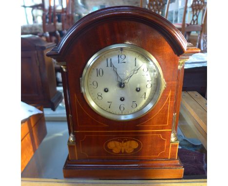 A mahogany case 8 day bracket clock, case inlaid with a butterfly to its front, Westminster quarter chimes, in working condit