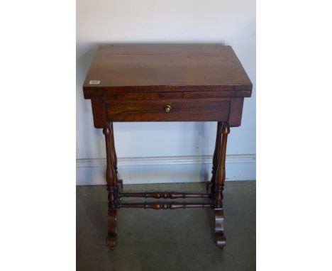 A Victorian rosewood games/work table with a fold over chess and backgammon top over a drawer, needs some restoration, basket