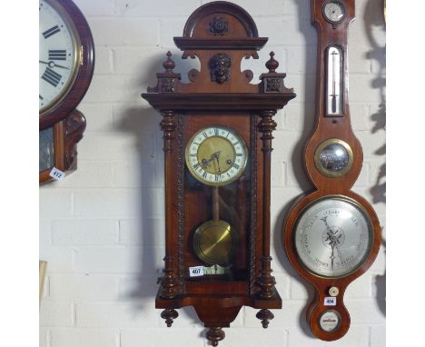 A walnut spring driven Vienna style wall clock, striking on a gong - 83cm tall, running in saleroom 