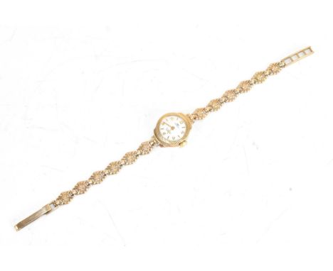 A Technos mid-20th century 9ct gold lady’s wristwatch, the circular dial with gilt baton and Arabic numeral markers, within a