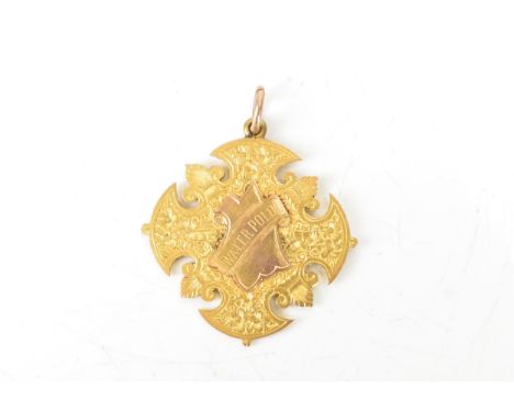 A yellow metal water polo medallion, tested as 9ct gold, of ornate cross form, the front engraved with foliate detail and cen