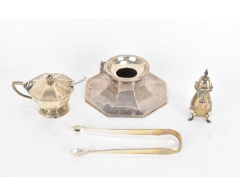 A group of silver to include a pair of George III sugar tongs and three early 20th century items comprising a mustard pot of 