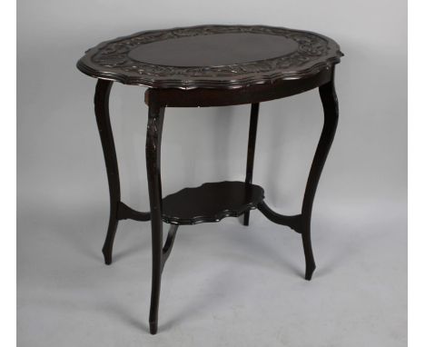 An Edwardian Mahogany Shaped Oval Topped Occasional Table with Stretcher Shelf and Carved Border, 76cm x 53cm 