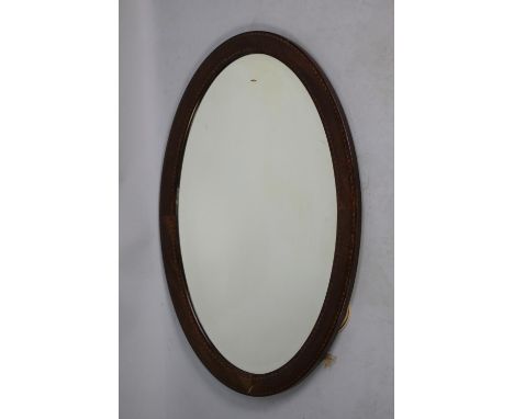 An Edwardian Inlaid Mahogany Framed Oval Wall Mirror, 77cm x 52cm 