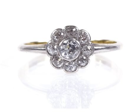 An 18ct gold diamond cluster flowerhead ring, central diamond approx 0.13ct, setting height 7.8mm, size K, 1.8g 