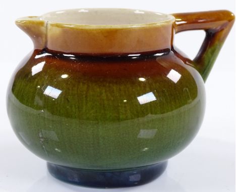 A Linthorpe brown / green glaze pottery jug, designed by Christopher Dresser, height 5.5cm 