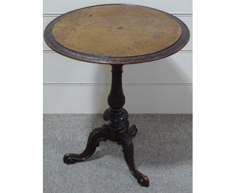 A Victorian walnut occasional table with carved edge, on carved tripod base, 24" across 