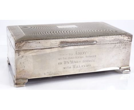 A rectangular silver cigarette box, with engine turned lid, by Alexander Clark &amp; Co Ltd, hallmarks Birmingham 1960, lengt